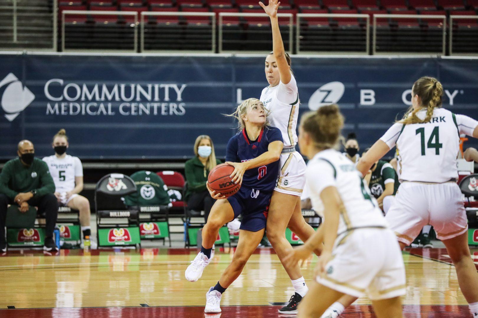 Fresno State guard Hanna Cavinder drives for a layup while being defended against Colorado State Rams on December 3, 2020, at the Save Mart Center. (Vendila Yang/ The Collegian)
