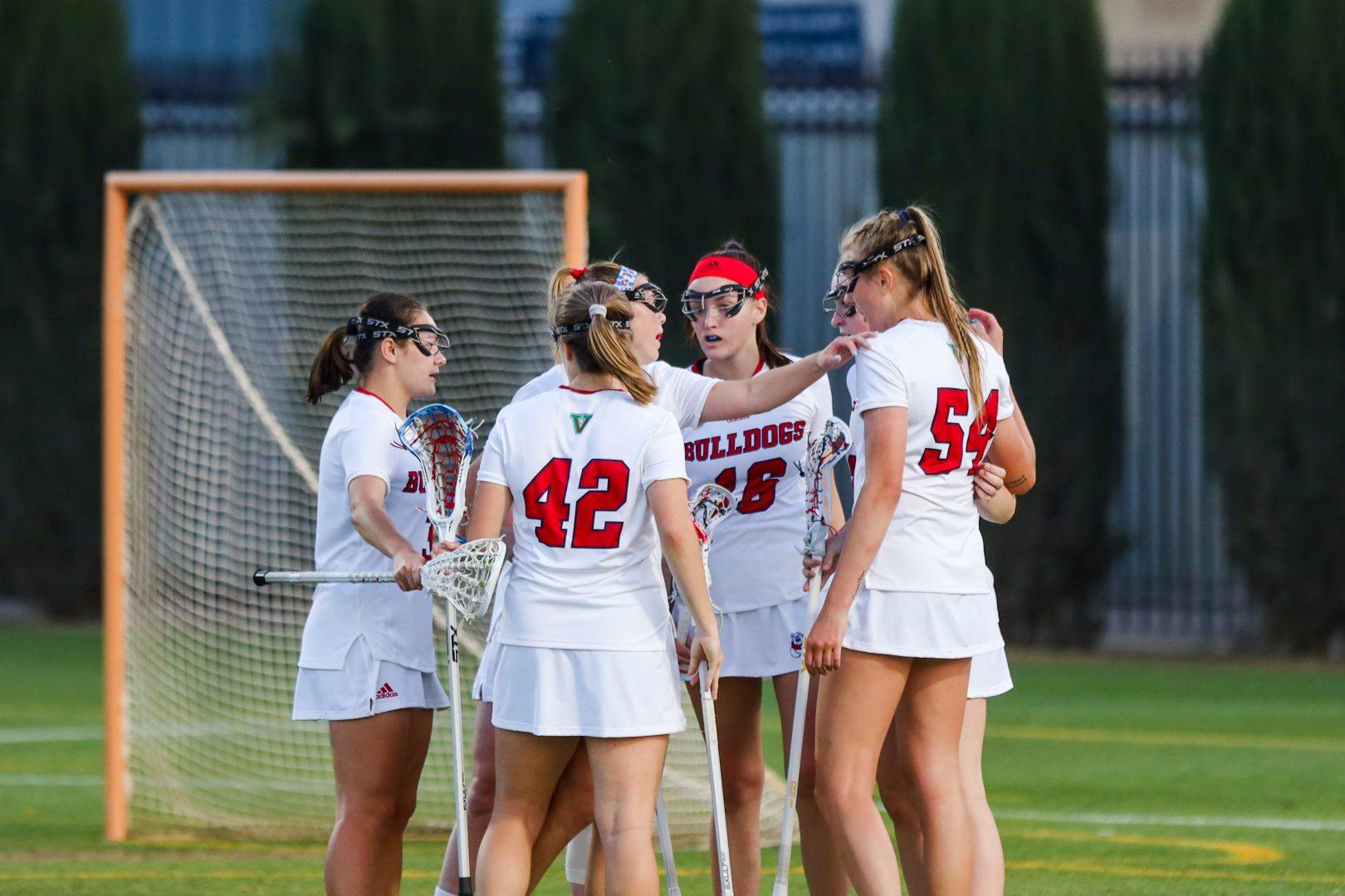  Fresno State women’s lacrosse celebrates a goal made in the first half of their home opener against Cal at Soccer and Lacrosse Stadium on Friday March 5, 2021. (Vendila Yang/ The Collegian)