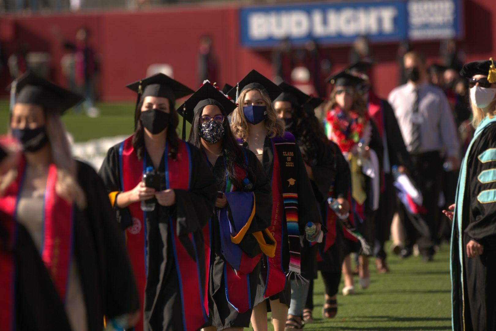 Graduates+of+the+Kremen+School+of+Education+and+Human+Development+walk+into+Bulldog+Stadium+for+their+commencement+ceremony+on+Friday%2C+May+14%2C+2021.+