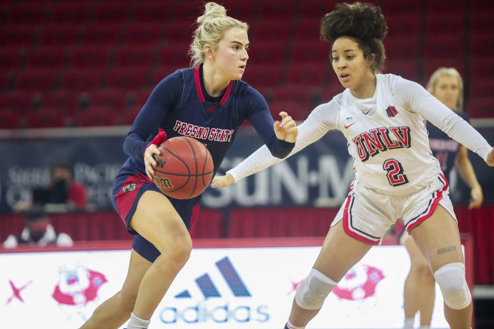 Fresno State guard Haley Cavinder drives in for a layup while being defended by UNLV guard Jasmine Singleton at the Save Mart Center on Saturday, Feb. 27, 2020. (Vendila Yang/The Collegian)