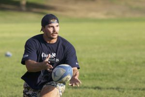 Rugby player Travis Hansen passes the ball during practice drill on Tuesday, Sept. 28, 2021, at Rotary West Park. (JesÃºs Cano/ The Collegian)