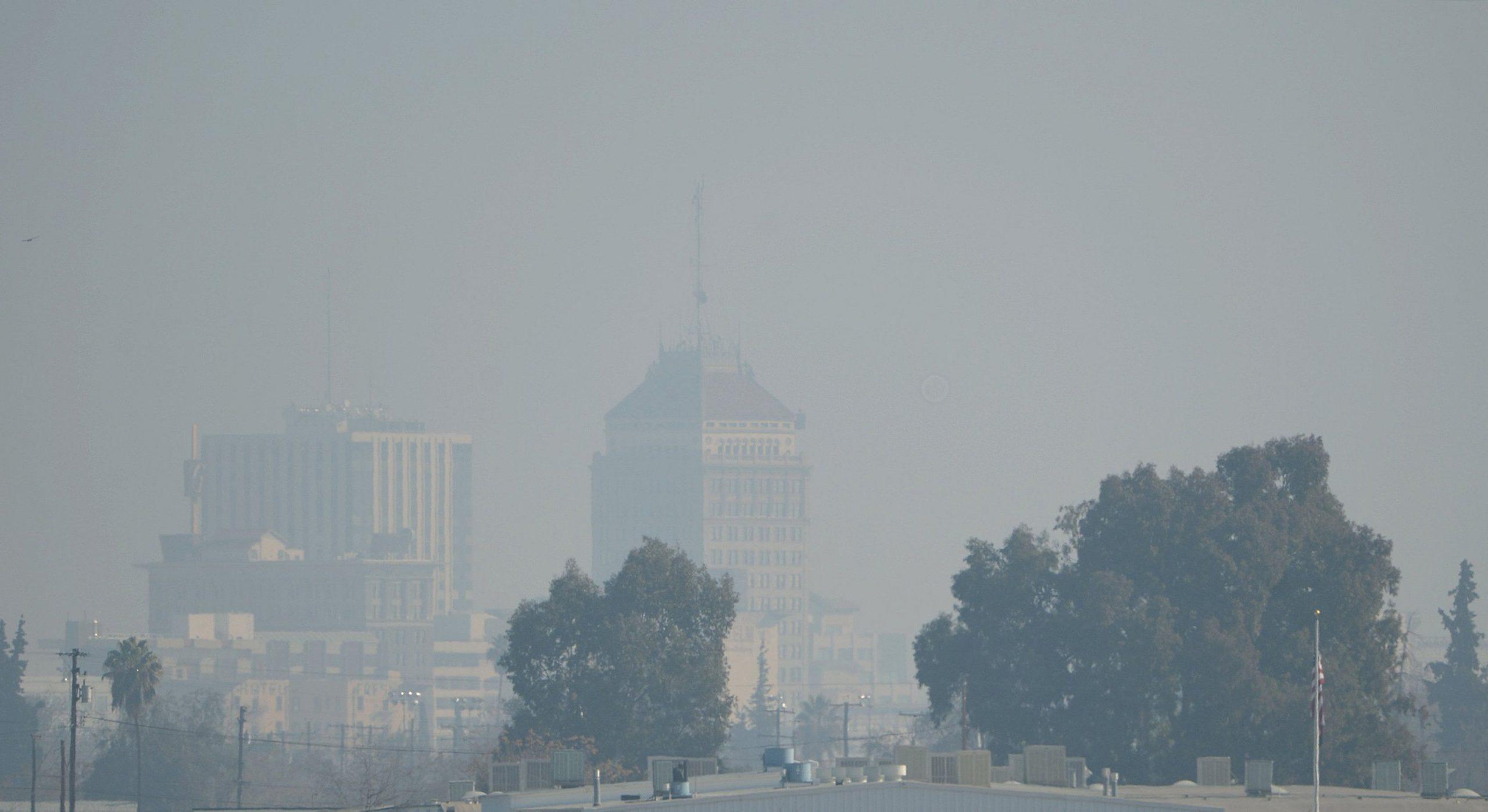 The downtown Fresno skyline with heavy haze in 2014. The Fresno State Ethics Center invited panelists to discuss questions regarding environmental issues in Fresno and throughout the Central Valley. (Craig Kohlruss/Fresno Bee/MCT)