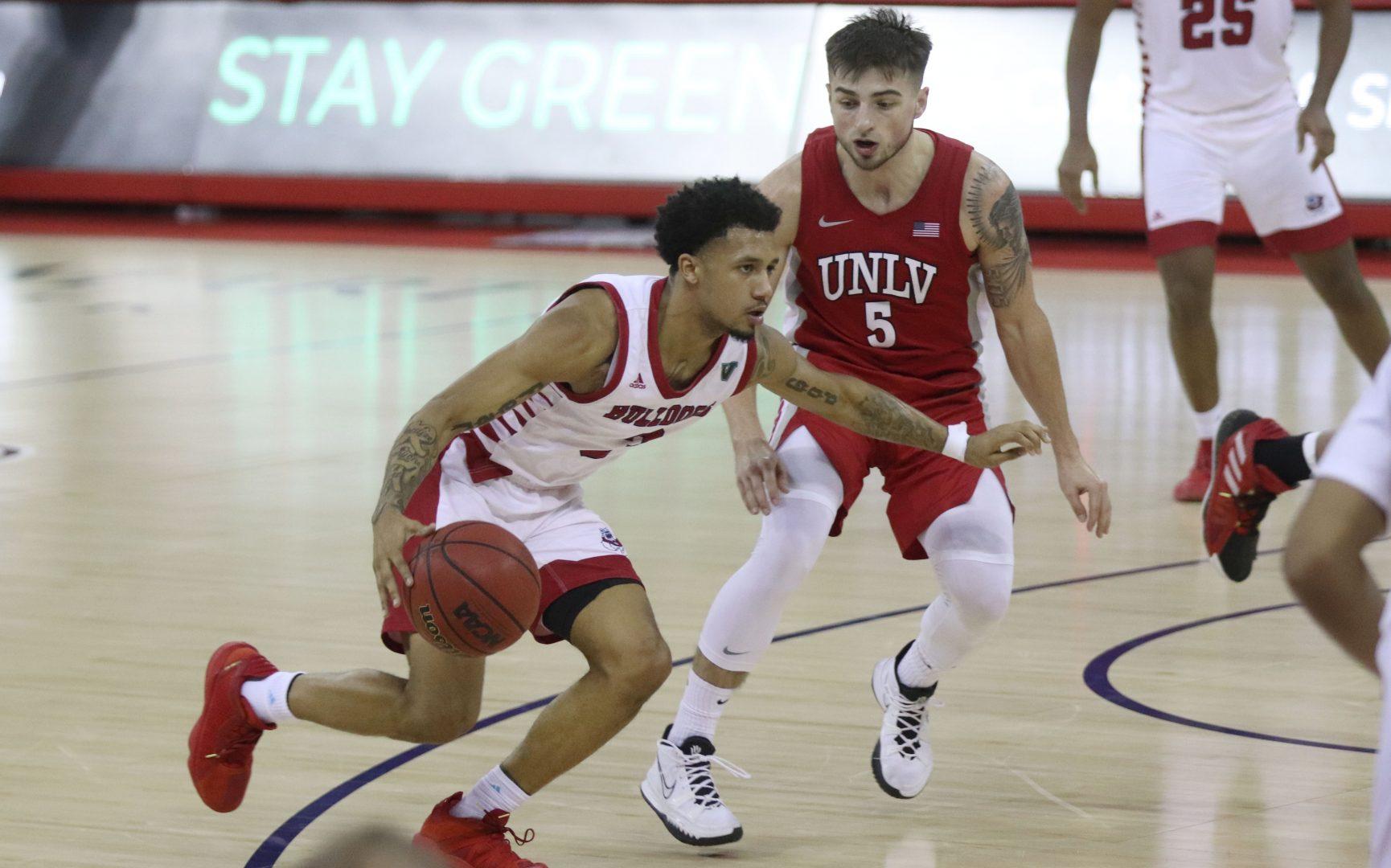 Fresno State guard, Isaiah Hill, dribbles the ball across the court in their game against UNLV Feb. 16, 2022 in the Save Mart Center. (Melina Kazanjian/ The Collegian)