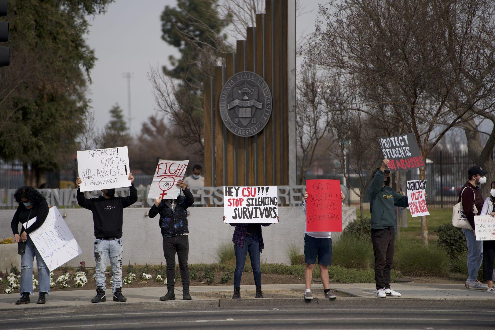 Protestors stood in front of the Fresno State sign on North Cedar and Shaw avenues on Feb. 5, 2022. (Wyatt Bible/ The Collegian)