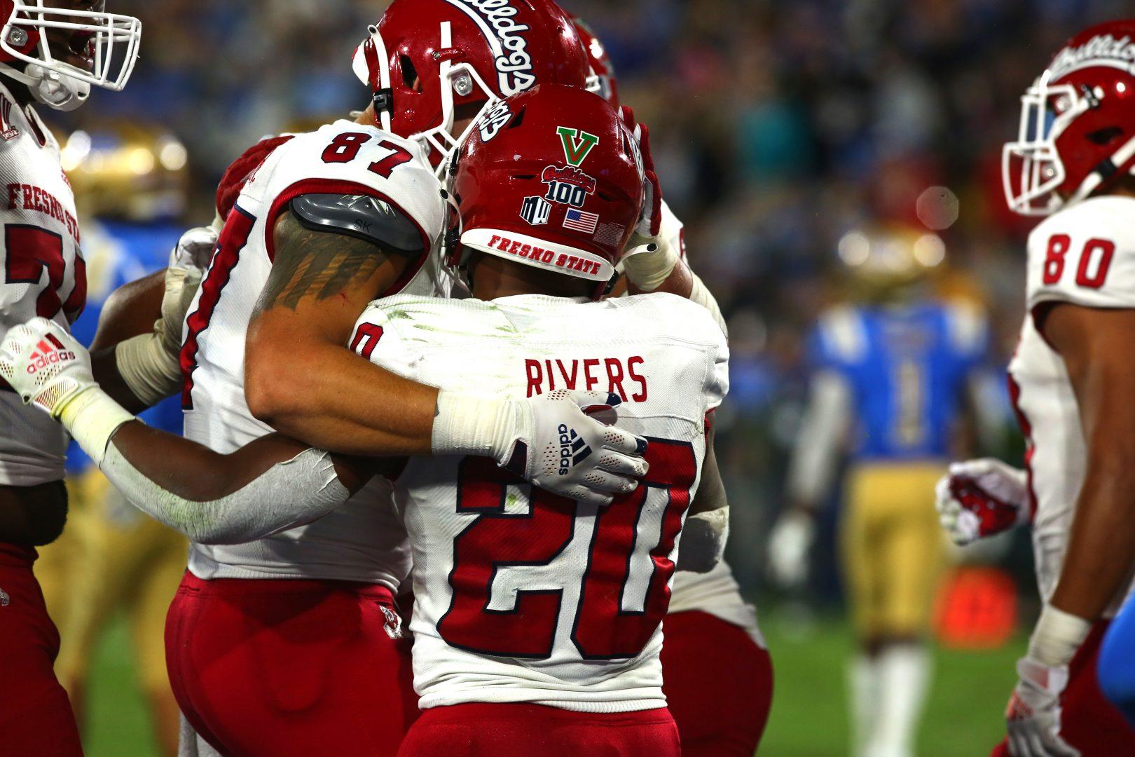 Ronnie Rivers celebrating with his teammate Raymond Pauwels Jr. after their
win against UCLA on Sept. 18, 2021. (Tyler Van Dyke/ The Collegian)