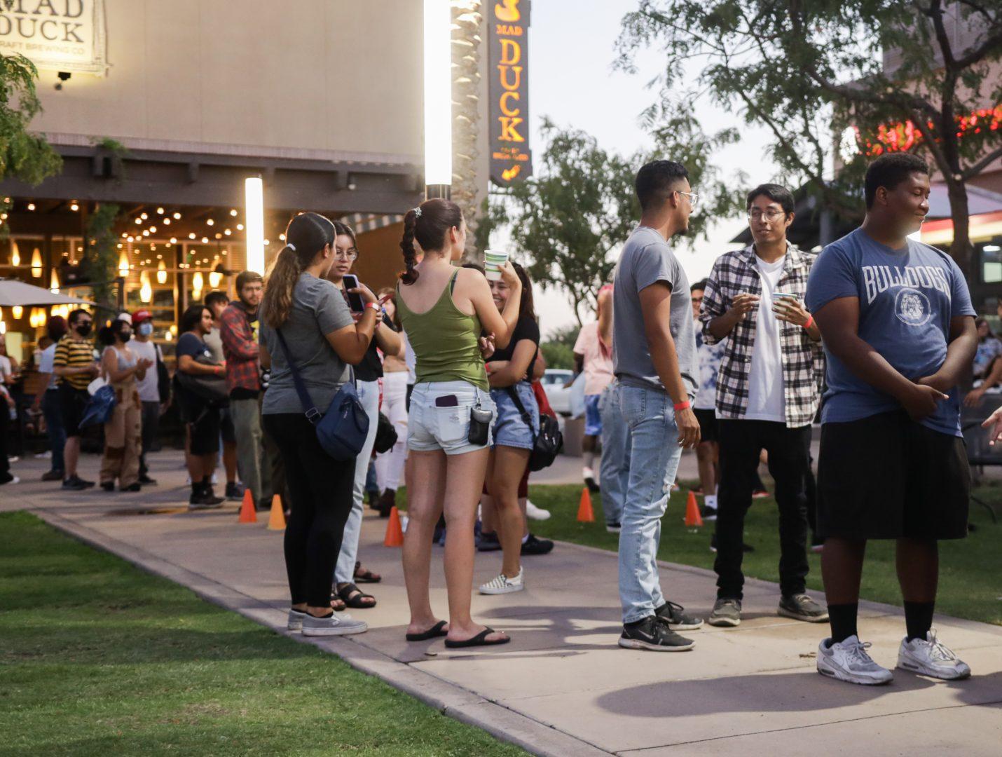 Students wait in line for a photo booth at Fresno States Night at Campus Pointe on Thursday, August 25, 2022. (Carlos Rene Castro/The Collegian)