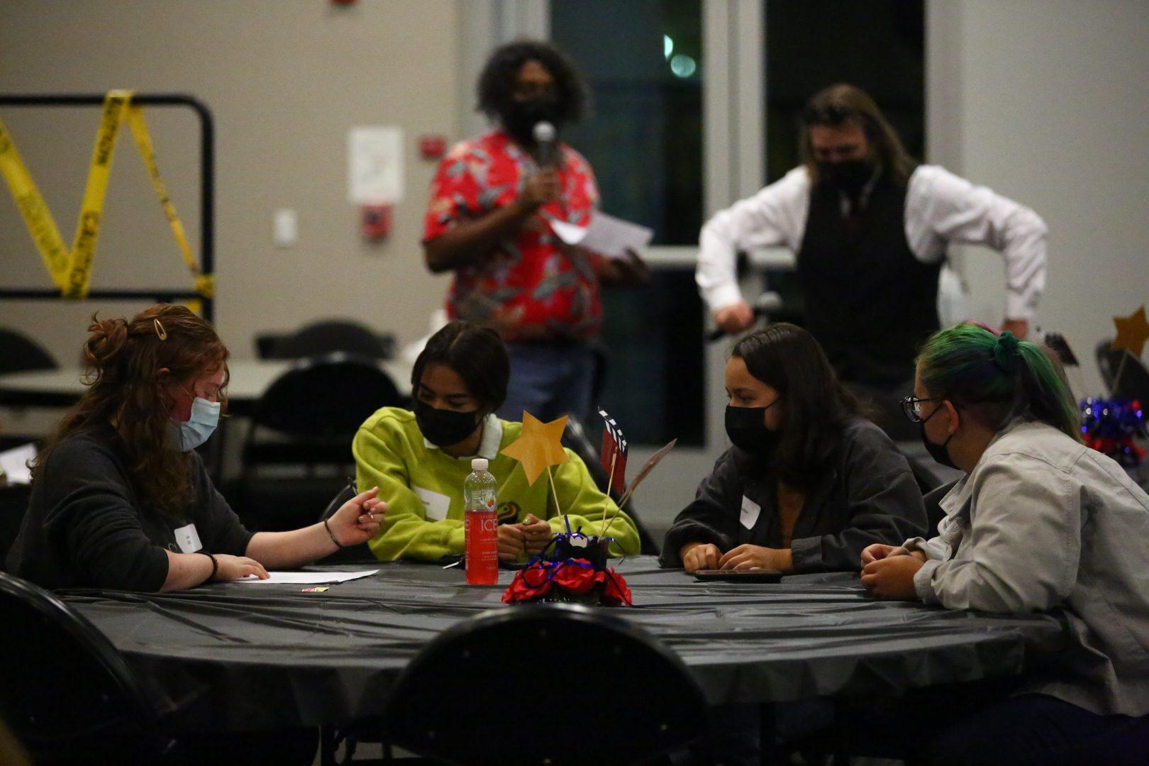 Students deliberate together during the Hollywood Murder Mystery event hosted by USU Productions in Oct. 2021. (Adam Ricardo Solis/The Collegian)