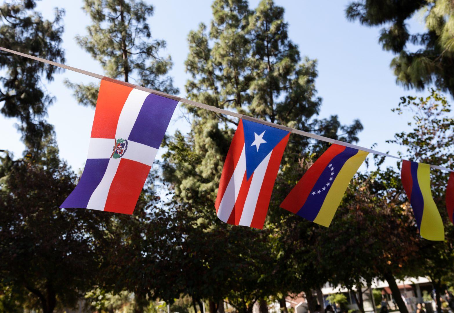 Flags decorate the Memorial Garden for La Bienvenida. (Carlos Rene Castro/The Collegian)