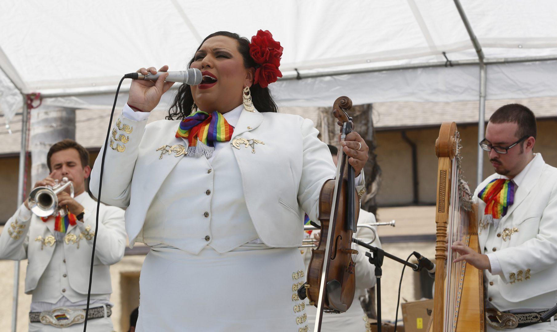 Natalia Melendez, center, who is believed to be the first openly transgender female mariachi performer, sings with Mariachi Arcoiris (Rainbow Mariachi) during a performance at a San Fernando LGBT Center event in San Fernando, Calif., on Aug. 15, 2015. (Anne Cusack/Los Angeles Times/TNS)