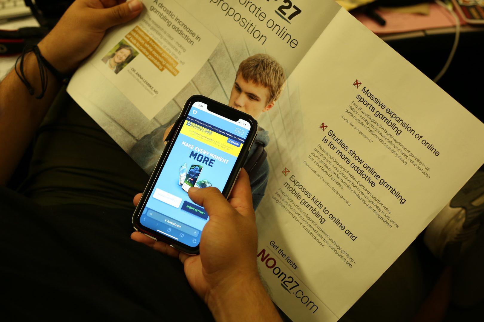 A pamphlet against Proposition 27 pictured with the mobile sports gambling app FanDuel. Propositions 27 and 26 will be on the ballot this November. (Ashley Flowers/The Collegian)