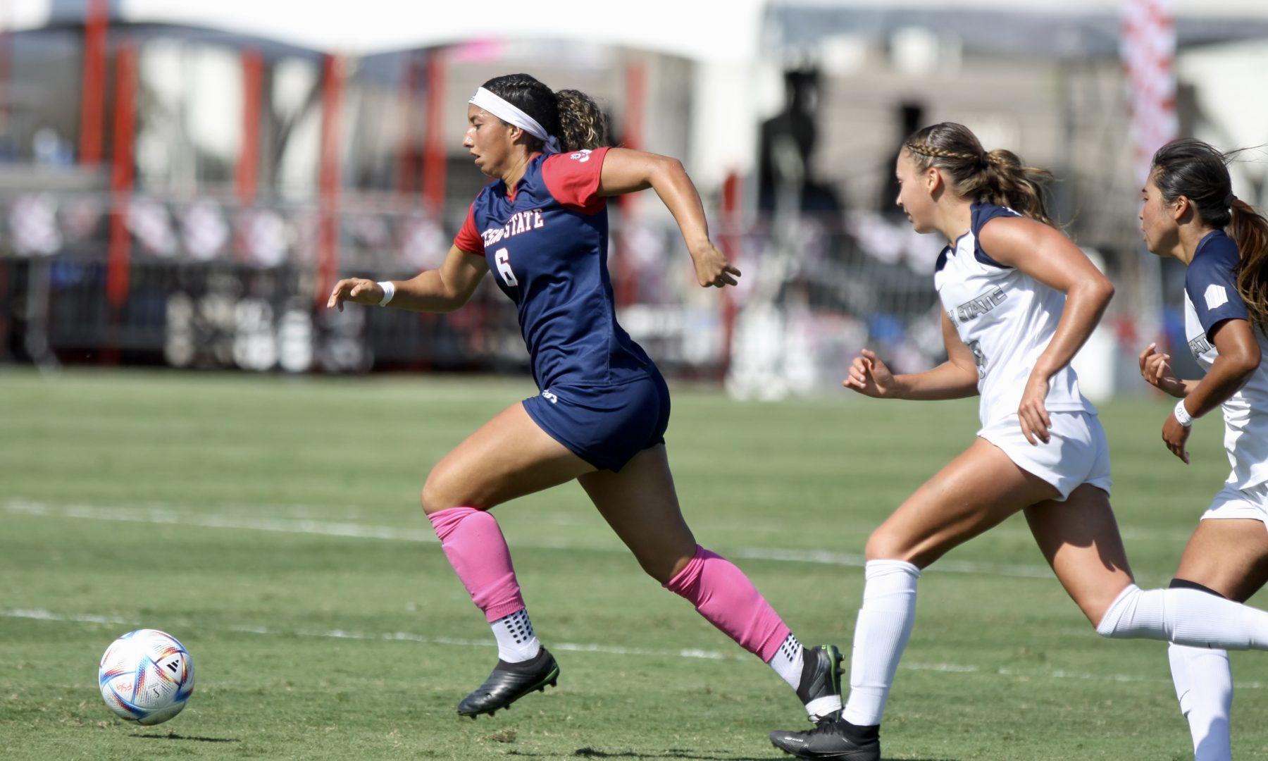 Kassandra Ceja (6) dribbles the ball down the field, looking to pass the ball to a teammate against Utah State. (Aidan Garaygordobil/ The Collegian)