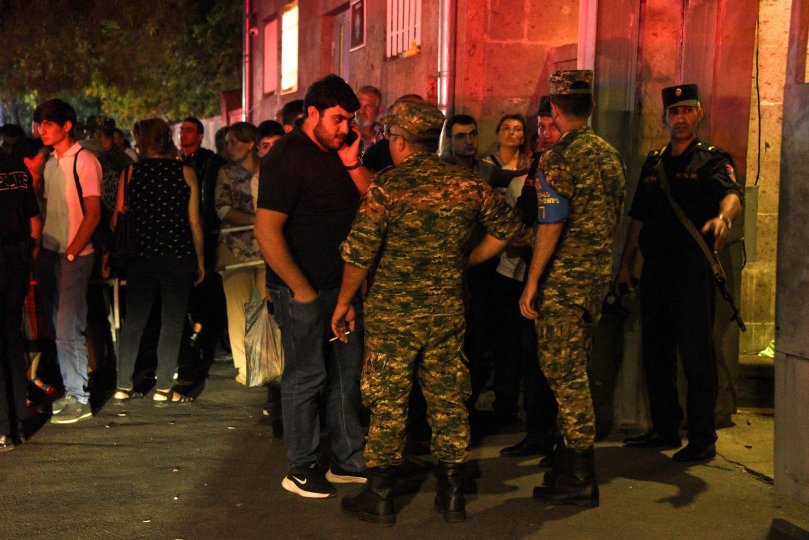 Relatives of servicemen, who were wounded in night border clashes between Armenia and Azerbaijan, gather outside a military hospital on Sept. 13, 2022, in Yerevan, Armenia. (Karen Minasyan/AFP/Getty Images/TNS)