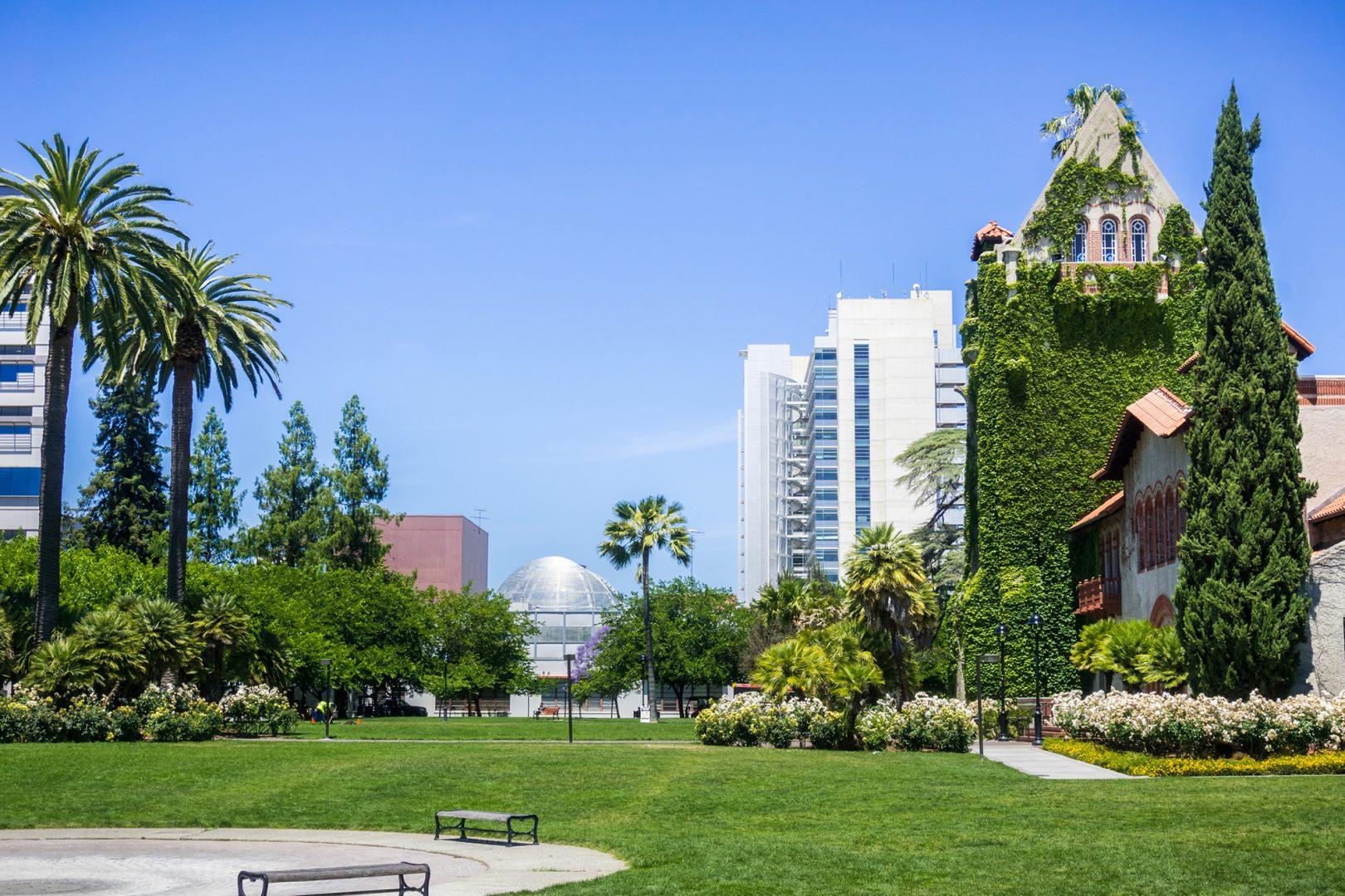 An old, ivy-covered building at San Jose State University, right, stands next to the modern City Hall building in San Jose, California. (Dreamstime/TNS)