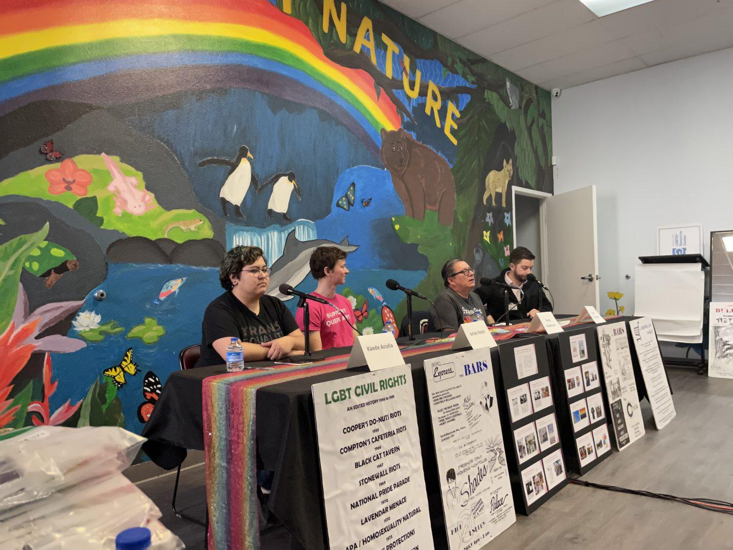 Panelists Kaede Coronado-AcuÃ±a (left), Arien Reed (second from left), Peter Robertson (second from right) and Justin St. George (right) pose in front of the Queer By Nature mural in Fresnos Economic Opportunities Commissions (EOC) LGBTQ+ Resource Center. (Ashley Flowers/The Collegian)