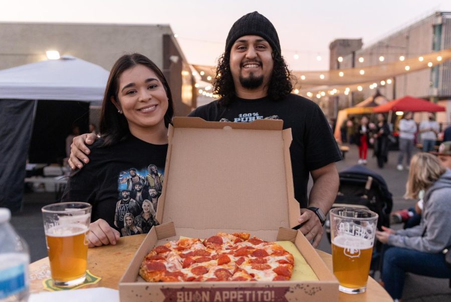 Eva Favela and Nathan Becerra enjoying a heart-shaped pizza from Brickology Pizza.