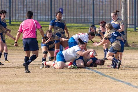 A Fresno State womens rugby player scores a try against the University of California, Davis, on Jan 28. at the Kinesiology Field. (Marcos Acosta/The Collegian)