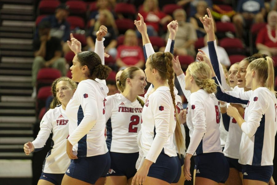 The Fresno State volleyball team celebrates a Bulldog point in the first Mountain West conference game of the season at the Save Mart Center in November 2022. (Blake Wolf/The Collegian)