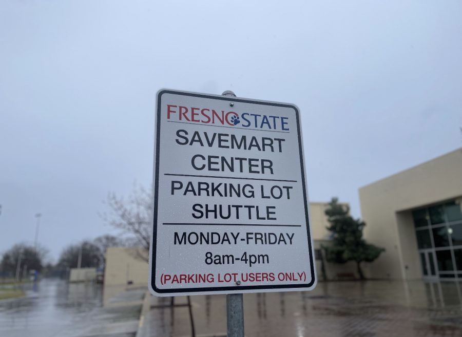 The shuttle service bus stop in front of the North Gym roundabout near Campus Drive Circle, with postings of the weekly schedule.