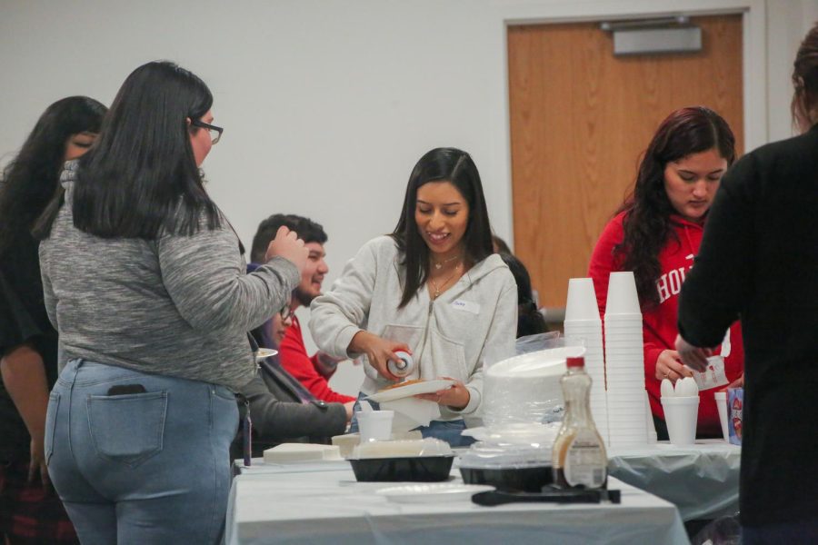 On Fresno State student serves whip cream on pancakes during Spotlight Events Pancake and Pajamas event at the Resnick Student Union on Jan. 31. (Manuel Hernandez/The Collegian)