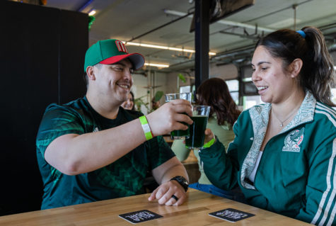 Newlyweds Julian Ruiz and Tania Muñoz enjoy a glass of Tioga-Sequoias Lucky 99 beer. (Carlos Rene Castro/ The Collegian)