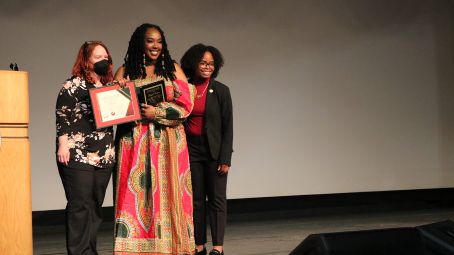 Schettler (left) and Williams (right) awarding Clayton the Africana Studies award. (Aileen Guzman/The Collegian)
