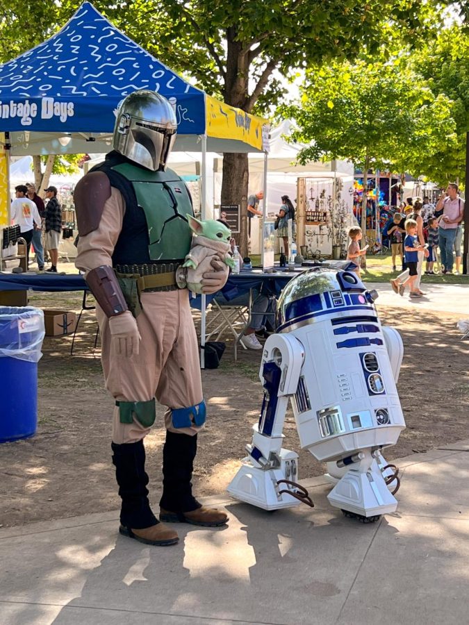 Actors portraying the Mandolorian (left) and R2D2 (right) entertain children during the 2022 Vintage Days. (Melina Kazanjian/The Collegian)