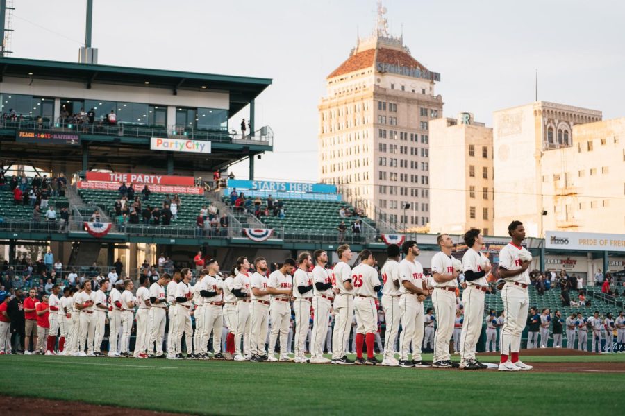 The Fresno Grizzlies stand for the National Anthem at the beginning of the 2023 home opener.