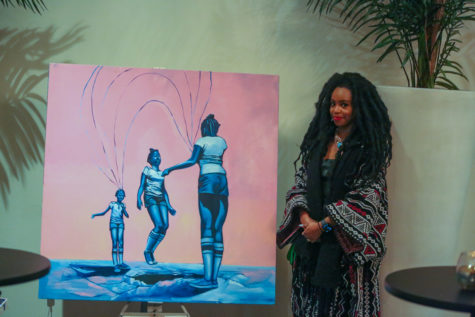 Audia Dixon poses beside her artwork as an artist-in-residence during the Trailblazers 2023 event that took place on Feb. 24. (Manuel Hernandez/The Collegian)