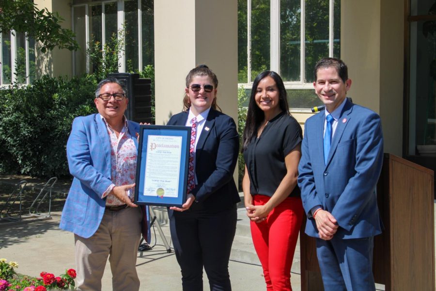 Fresno City Council Vice President Annalisa Perea (center right) presents a proclamation of June as Pride Month for the city of Fresno and Fresno State to Peter Robertson (left), Lexey Jenkins (center left) and Fresno State President Saúl Jiménez-Sandoval (right) on June 1 outside of the Frank W. Thomas Building.