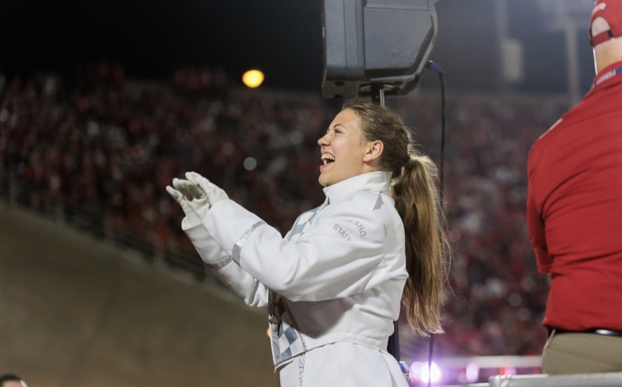 Kristine Kemmer directs the Bulldog Marching Band at a football game. 