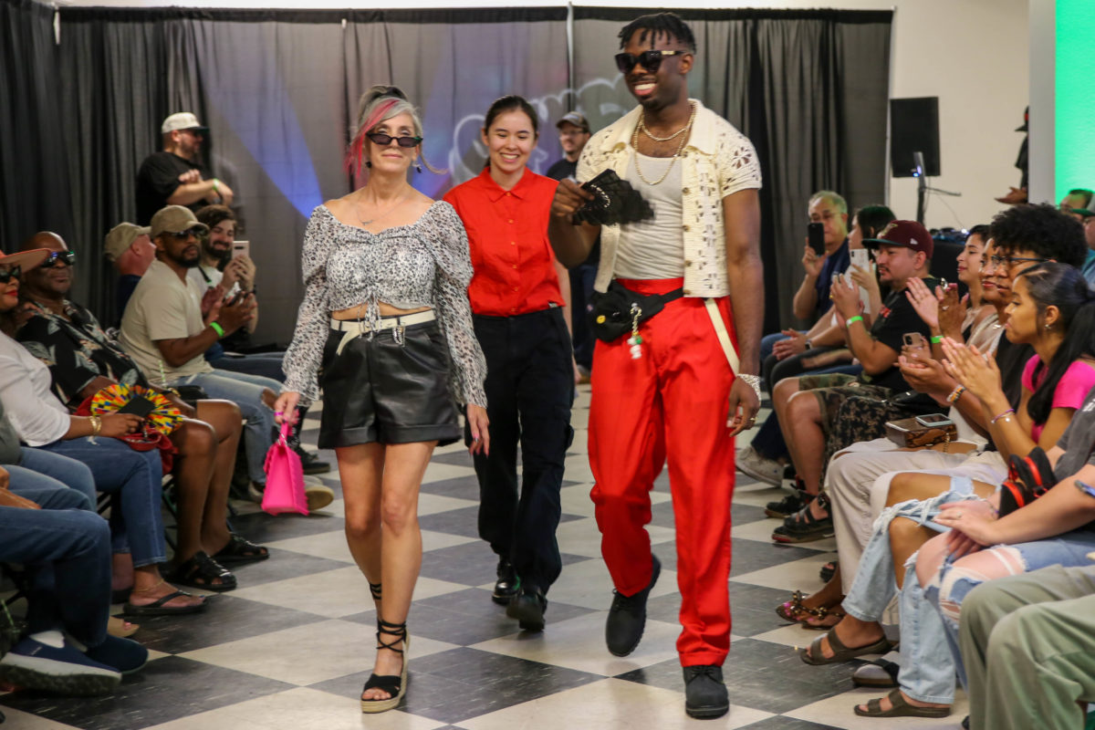 Sarah Thong (middle), walks behind models she dressed in clothing and accessories found in shops on Fulton Street. (Sarah Delgado/The Collegian)