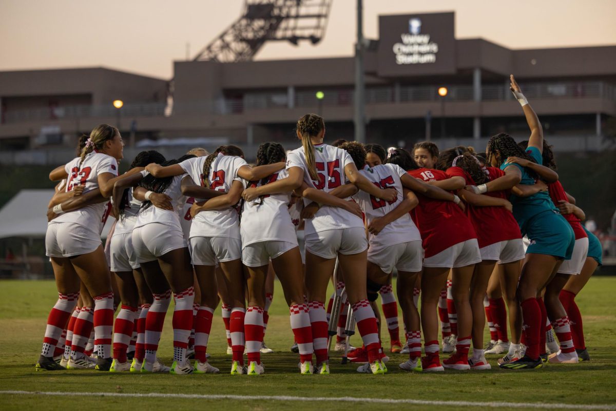 The Fresno State soccer team huddles and cheers before its match. 
