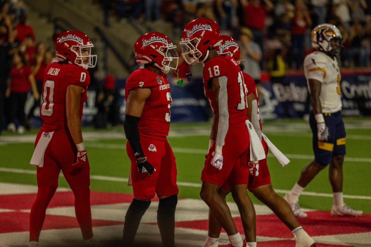 Fresno State football players Erik Brooks and Jalen Moss celebrate after a touchdown. 