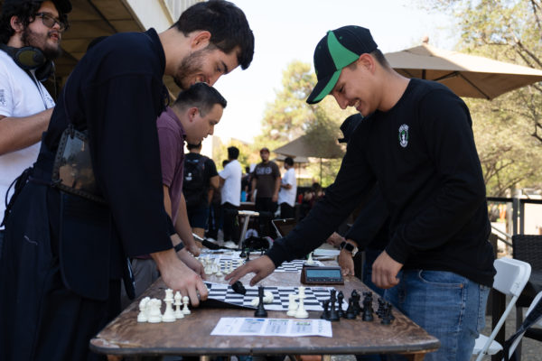 Students engage in a game of chess with the Chess Club during Traditions Day. (Blake Wolf/The Collegian)