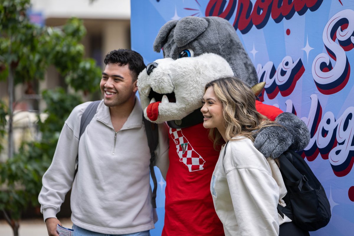 Fresno State students taking photos with Fresno State mascot Time-Out. (Jacqueline Carrillo/The Collegian)