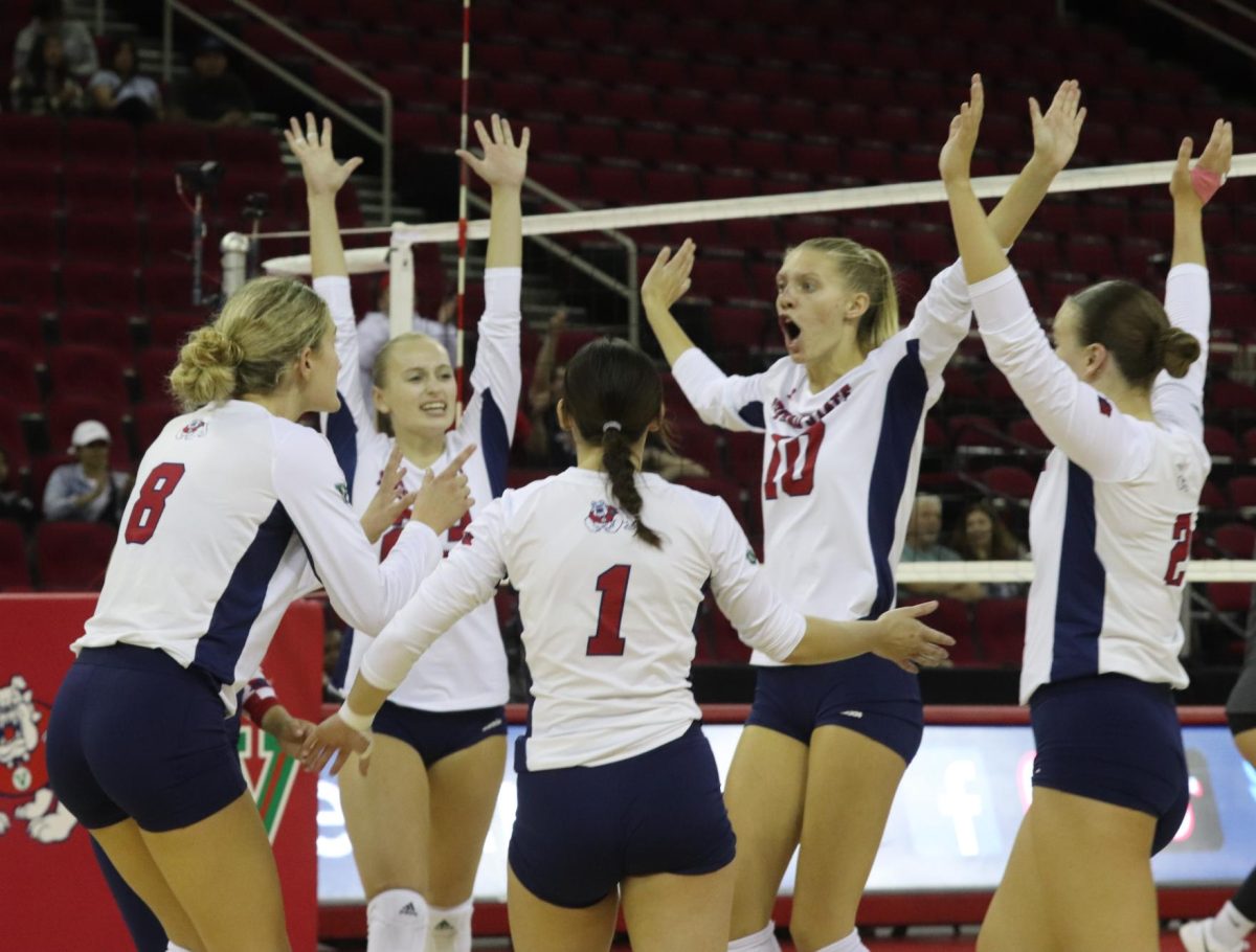 The Fresno State womens volleyball team celebrates after earning a point against San Diego State on Oct. 12 2023 at the Save Mart Center.