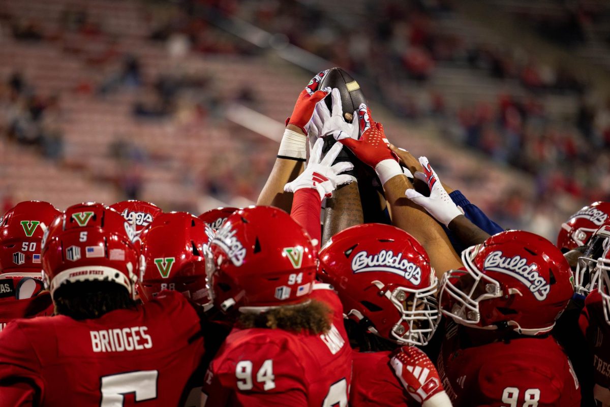 The+Fresno+State+football+team+huddles+around+the+ball+after+beating+UNLV+at+Valley+Childrens+Stadium+on+Oct.+28.++