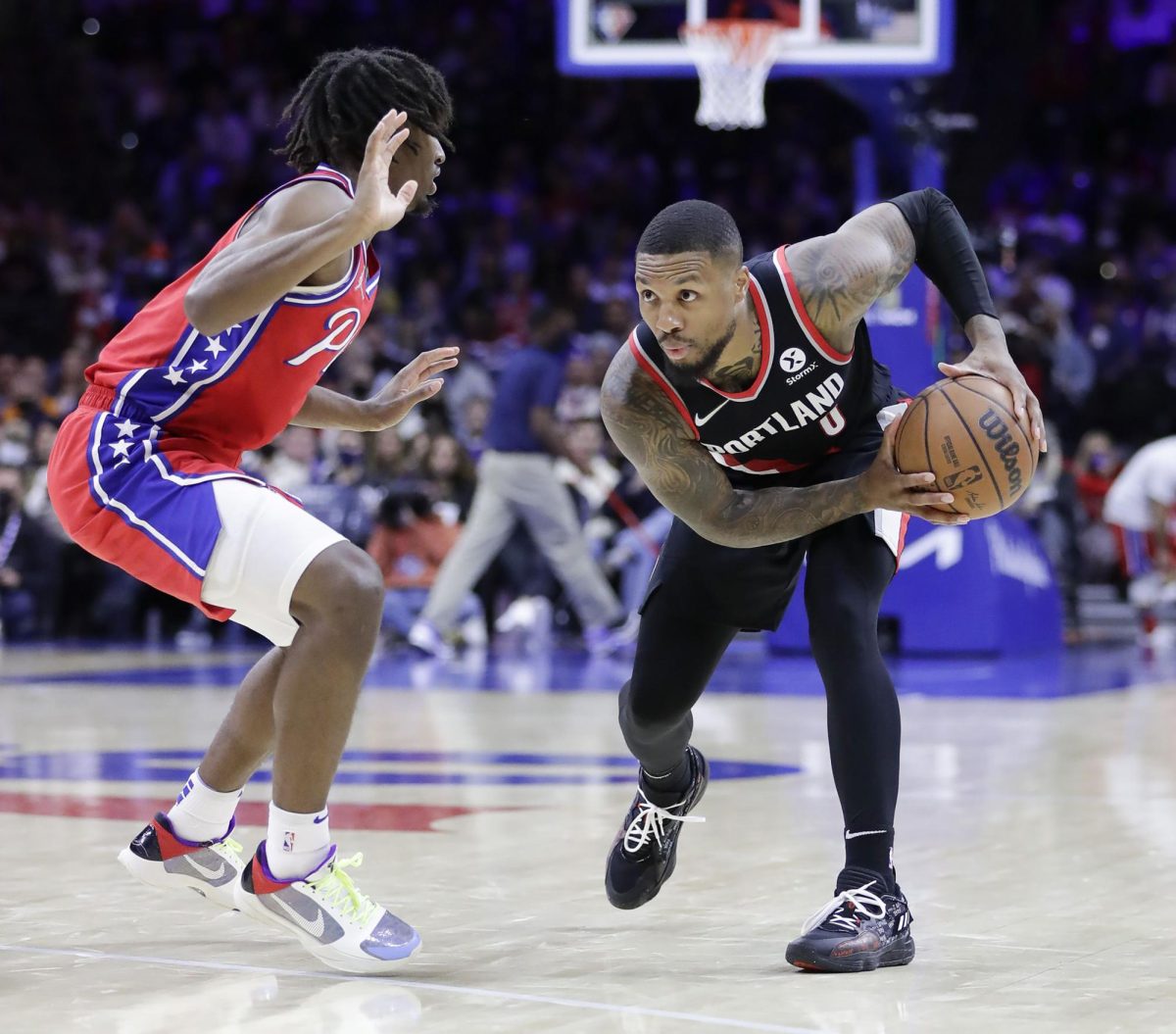 Portland Trail Blazers guard Damian Lillard holds the basketball against Sixers guard Tyrese Maxey on Nov. 1, 2021, in Philadelphia. 