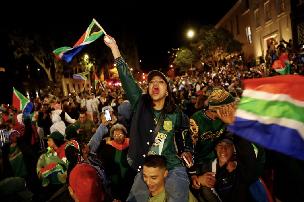 Fans of the South African rugby team cheer after the victory. 