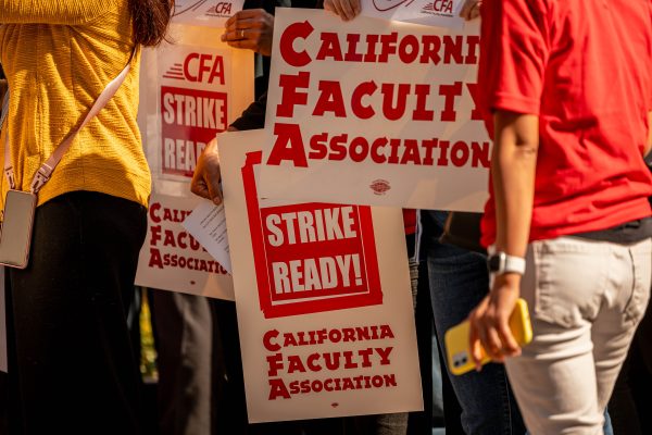 Poster signs that say CFA, STRIKE READY! at the Fresno State Memorial Fountain on Nov. 7. The CFA held a 12% Rally as a protest before they decided to strike.