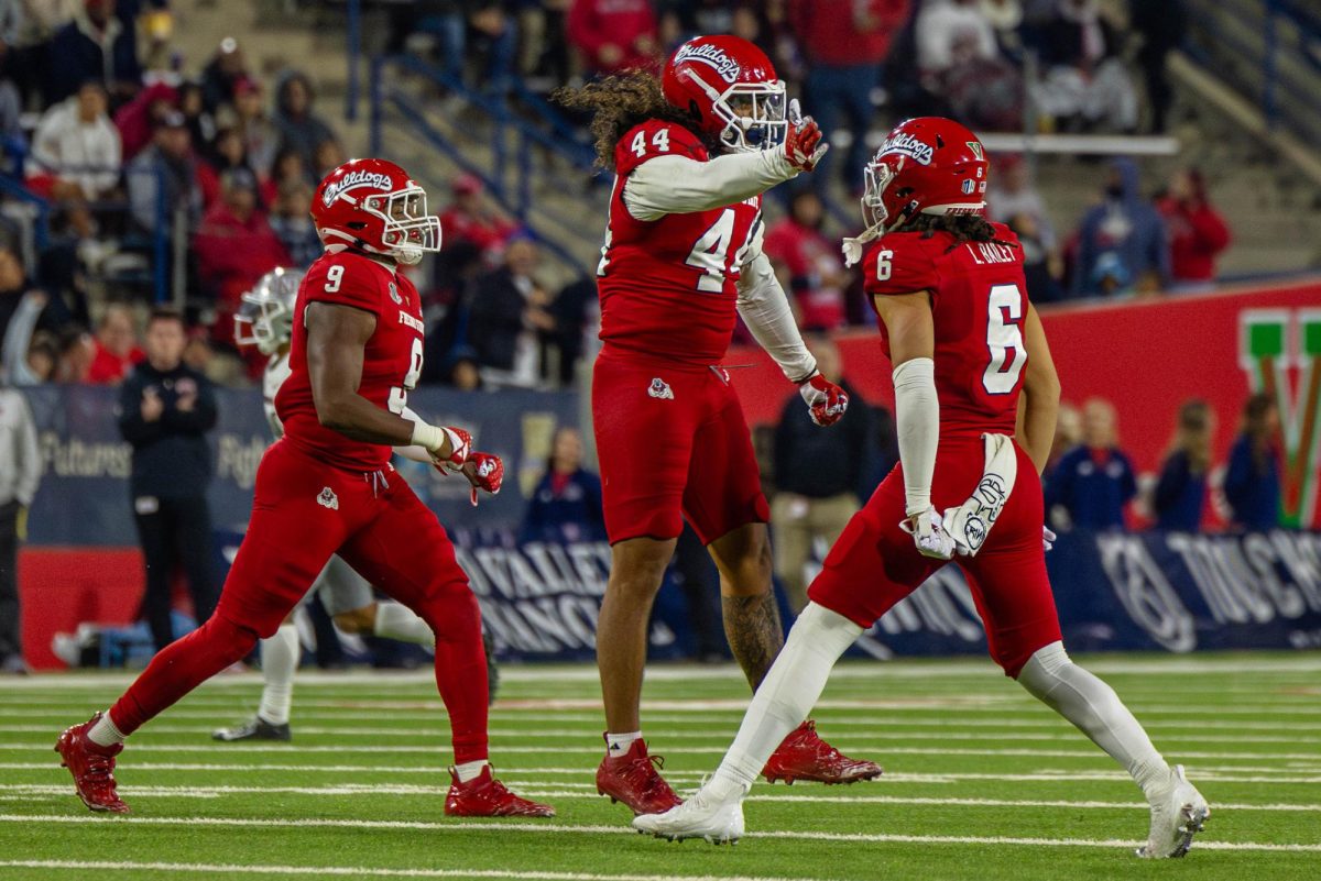 Tuasivi Nomura (left) and Levelle Bailey (right) celebrate together after a play against UNLV at Valley Childrens Stadium on Oct. 28. 