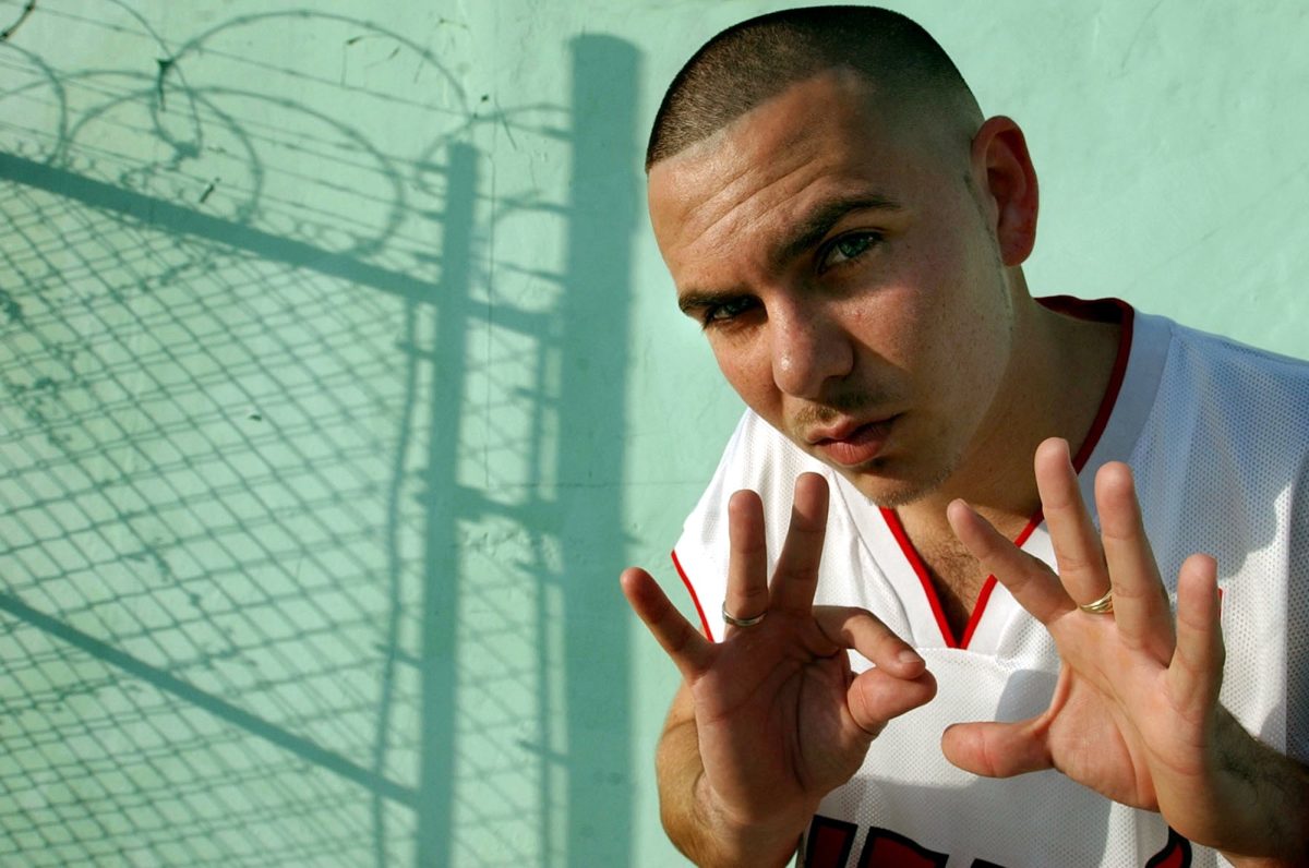 Miami-based rapper Pitbull (Armando Christian Perez) hangs out in the neighborhood he grew up in Miami, Florida, on February 5, 2003. He is signaling 305, the Miami area code. 