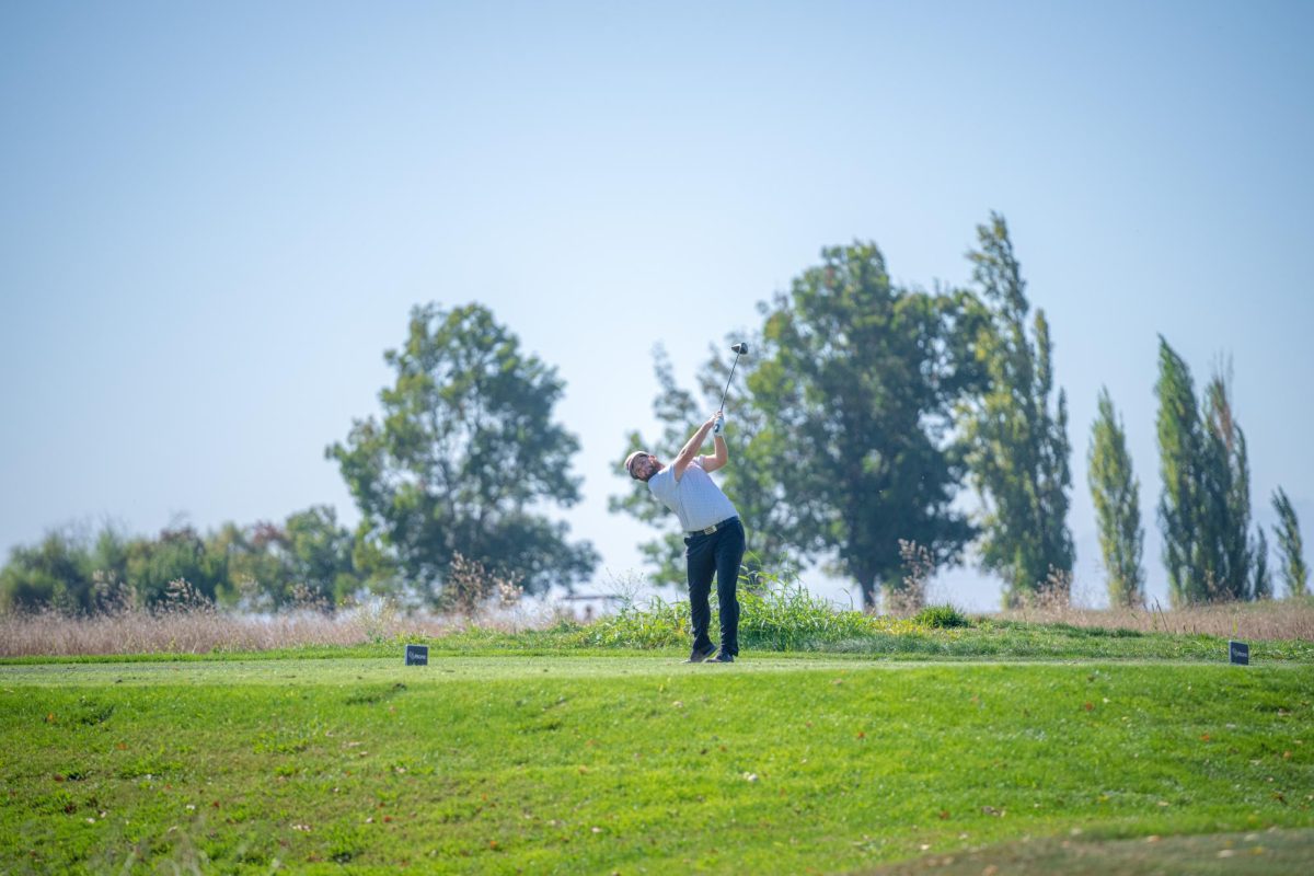 Fresno State senior golfer, Matthew Sutherland hits ball in golf match.