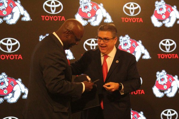 Fresno State Athletic Director Terry Tumey (left) accepts a Fresno State cap from university President Dr. Joseph I. Castro (right) on June 25, 2018. 