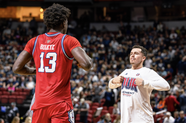 Enoch Boakye (left) and Steven Vasquez (right) do a handshake during the starting lineup announcement against Utah State, on March 14, at the Thomas & Mack Center. 
