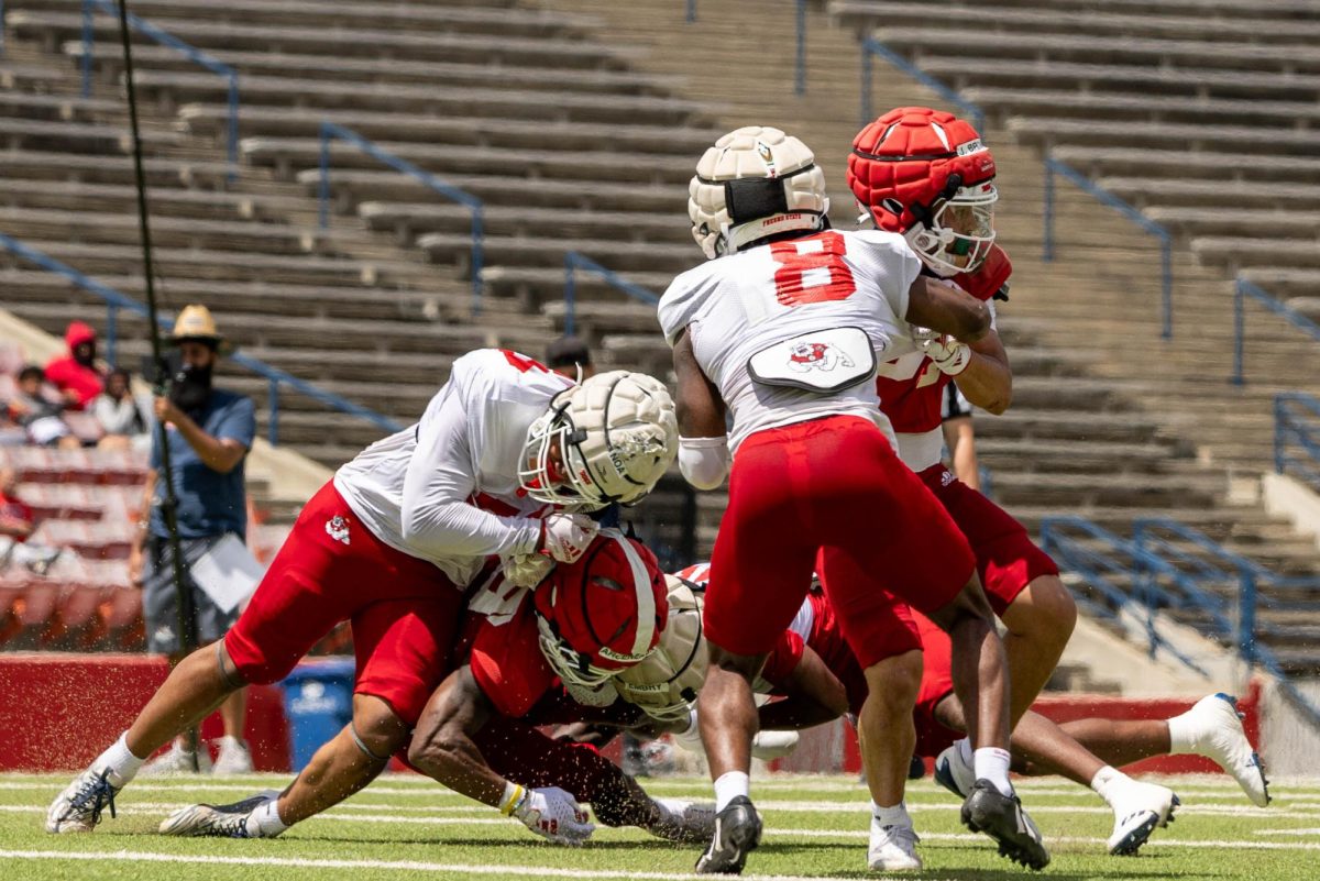 Fresno State football players tackle each other during a scrimmage at the Spring Preview on April 27 at Valley Childrens Stadium.