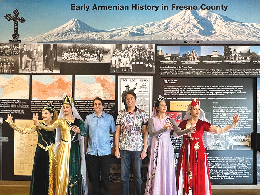 Jason Ahronian, center left, and Jeff Ahronian, at the “Armenians in Fresno County” exhibit.
