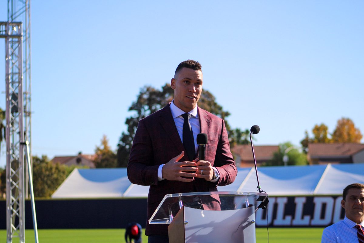 Aaron Judge speaking at podium for jersey retirement on Nov. 19, 2023 at Pete Beiden Field at Bob Bennett Stadium.