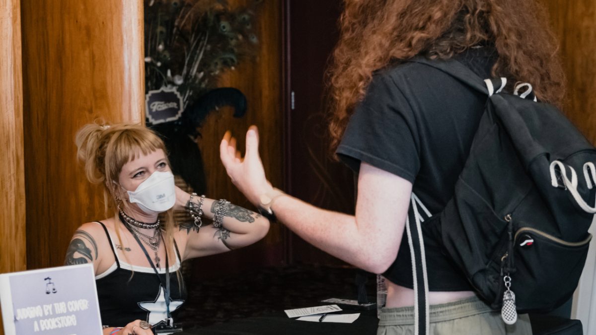 Madeline Pendleton doing a book signing at the Queer Housing Summit in Fresno, on August 24, 2024. Courtesy of Arthur Robinson. 