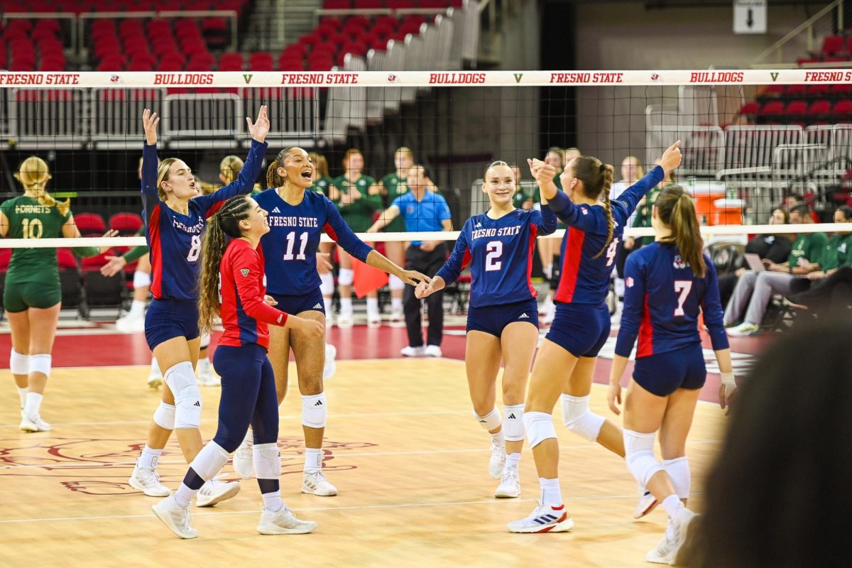 Addison Haluska (4) celebrates with her teammates after a point during the team's victory over Sacramento State on September 21, 2024. 